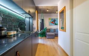 a kitchen with a sink and a living room at New Gudauri Twins in Gudauri