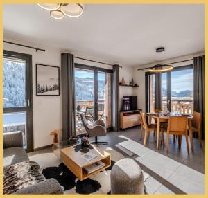 a living room with a couch and a table at L'évasion I T3 I Les Gets in Les Gets