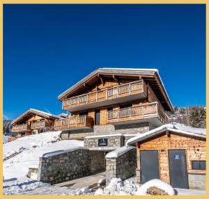 a log cabin with snow on the ground at L'évasion I T3 I Les Gets in Les Gets