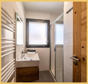 a bathroom with a sink and a shower at L'évasion I T3 I Les Gets in Les Gets +35 photos