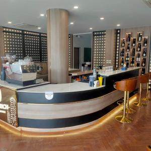 a bar in a hotel lobby with a counter at The Rich Cafe & Hostel in Pattaya South