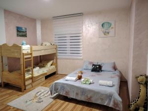 a childs bedroom with a bunk bed and a crib at Apartman Raj in Vrnjačka Banja