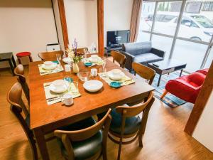 a dining room with a wooden table and chairs at Family Villa KASAMA - Vacation STAY 42429v in Kasama