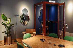 ein Esszimmer mit einem Tisch und grünen Stühlen in der Unterkunft Scandic Go, Grensen 20 in Oslo