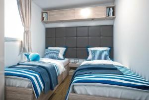 Ένα ή περισσότερα κρεβάτια σε δωμάτιο στο Victoria Mobilehome in Padova Premium Camping Resort +39 φωτογραφίες