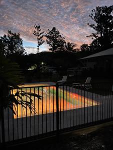 a fence with a sunset in the background at King Safari Tent 5 in Nelly Bay +5 photos