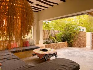 a living room with a table and a large window at Banana Shamba Estate in Lamu