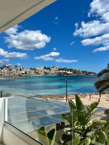 a view of the beach from the balcony of a house at Apartamentos Llobet Ibiza in Ibiza Town
