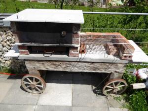 a wooden barbecue cart with a cage on it at Ferienhof Haus Sulztal in Berching +54 photos