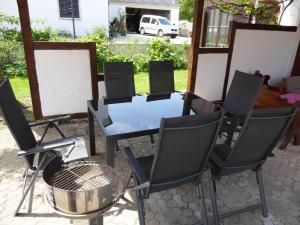 a group of chairs and a table and a grill at Ferienhof Haus Sulztal in Berching