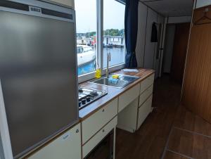a kitchen with a sink and a window at Floating Apartments at Rechlin Harbor by Kuhnle-Tours in Rechlin