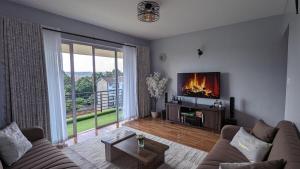 a living room with a couch and a tv at you are most welcome, feel at home in Makomboki