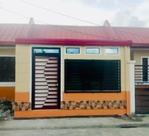 a small house with a red roof and a garage at Stay at Amazing Grace, whole unit- VCDU subdivision , Mabini Plains in Mabini
