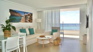 a living room with a couch and a table at Apartamentos Llobet Ibiza in Ibiza Town +95 photos