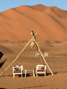 a structure in the middle of a desert at Horaz Merzouga Camp in Merzouga