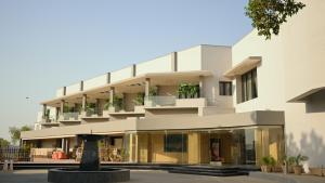 a large white building with balconies and a fountain at RT Grace Royal Taj Hotel Sukkur in Sukkur