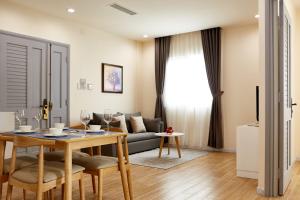a living room with a table and a couch at 8B Aparthotel in Ho Chi Minh City