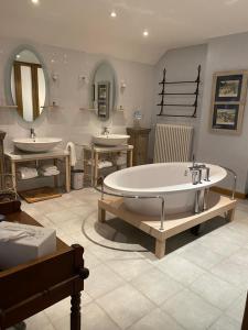a bathroom with two sinks and a large tub at Carpe diem in Massangis