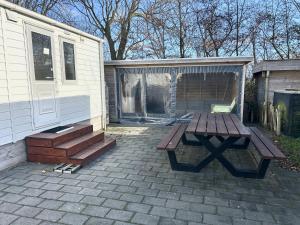 a picnic table and a gazebo in a backyard at Chalet 240 in Petten