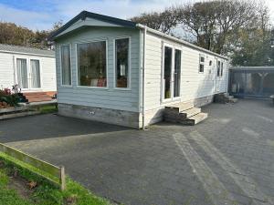 a tiny house sitting on top of a patio at Chalet 240 in Petten