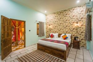 a bedroom with a bed in a room with a door at The Second Home Jaisalmer in Jaisalmer
