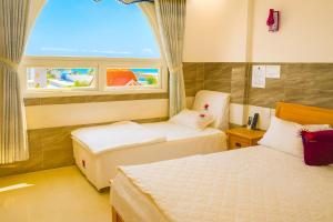 Ένα ή περισσότερα κρεβάτια σε δωμάτιο στο Thái Dương Hotel