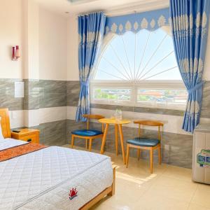 Ένα ή περισσότερα κρεβάτια σε δωμάτιο στο Thái Dương Hotel