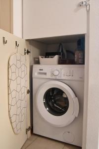 Beaune Levernois - Piscine Chauffée, Sauna et Golf في ليفيرنوا: غسالة ومجفف في غرفة صغيرة +6 صور