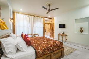 a bedroom with a bed and a ceiling fan at The Second Home Jaisalmer in Jaisalmer