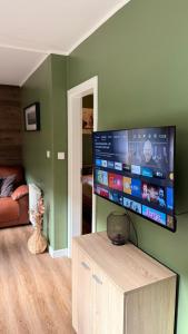 a living room with a flat screen tv on a wall at Ferienhaus mit Privatsauna in Lage