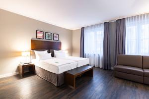 Ένα ή περισσότερα κρεβάτια σε δωμάτιο στο Garner Hotel Friedrichshafen by IHG