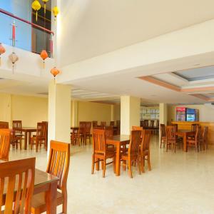a dining room with wooden tables and chairs at Long Anh Hotel in Lao Cai