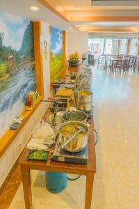 a buffet line with many pots and pans of food at Long Anh Hotel in Lao Cai +45 photos