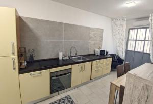 a kitchen with a sink and a refrigerator at Castelnuovo Workx in Castelnuovo