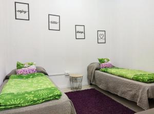two beds in a room with pictures on the wall at Castelnuovo Workx in Castelnuovo