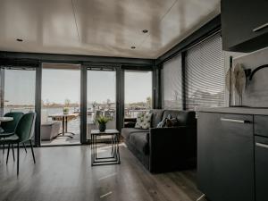 a living room with a couch and a table at Houseboat Uitgeest with Air Conditioning | 4 people in Uitgeest