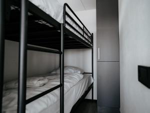 a couple of bunk beds in a room at Houseboat Uitgeest with Air Conditioning | 4 people in Uitgeest