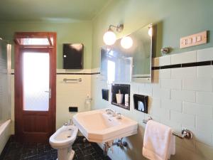 a bathroom with a sink and a toilet and a mirror at Dimora Cavour in Monopoli