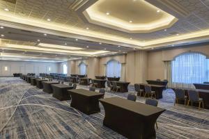 a room with rows of tables and chairs at Marriott Columbia in Columbia