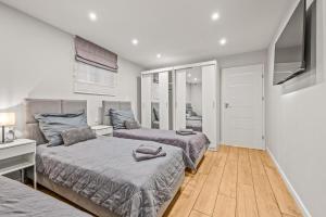 a bedroom with two beds and a flat screen tv at Central Platinum Apartments 24 in Rybnik