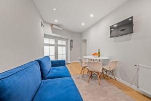 a blue couch in a living room with a table at Central Platinum Apartments 24 in Rybnik