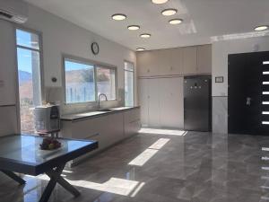 a large kitchen with a table in the middle at שושנת מטולה in Metulla