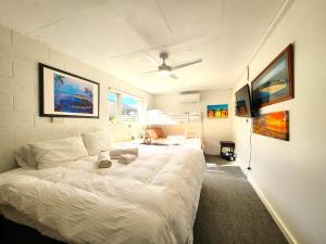 a bedroom with a large white bed with a ceiling at Aloha Bayside lower ground suite with full kitchen in Highett
