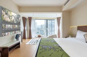 a bedroom with a bed and a large window at Skyline Riverview Apartments in Chongqing