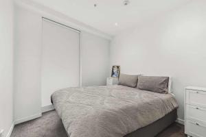 a bedroom with a bed and a white wall at 3-Bedroom CBD Elevate Apartment in Wellington +6 photos