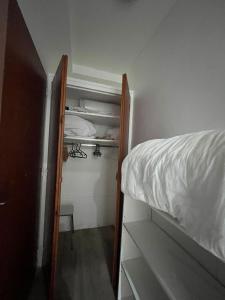 a small bedroom with a bed and a closet at Le Studio Louise Pratique & Central in Brides-les-Bains