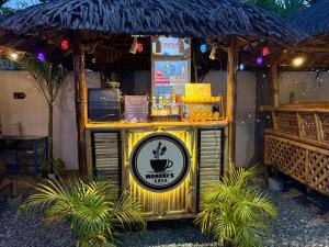 a drink stand in a restaurant with palm trees at Mongki's Pension House in Puerto Princesa City