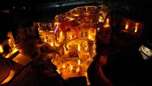 an aerial view of a building at night with lights at My Cave Suites in Nevsehir +184 photos