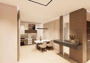 een keuken en eetkamer met een tafel en stoelen bij Havens Apartamen in Durrës