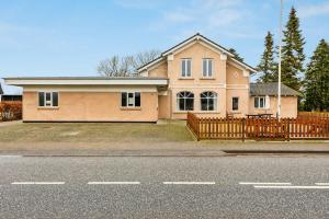 a house with a wooden fence in front of a street at Big Family Home Near Romo Spacious for 30 Guests in Skærbæk +62 photos
